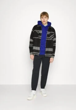 Champion RochesterELASTIC CUFF PANTS - Träningsbyxor - Black -Stil och Komfort Butik 683904507a5d43b9a4babe6e51014139