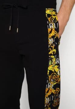 Versace Jeans CouturePRINT LOGO COUTURE - Träningsbyxor - Black/gold -Stil och Komfort Butik 77274c146a7045d290cf8d83987f3ad6